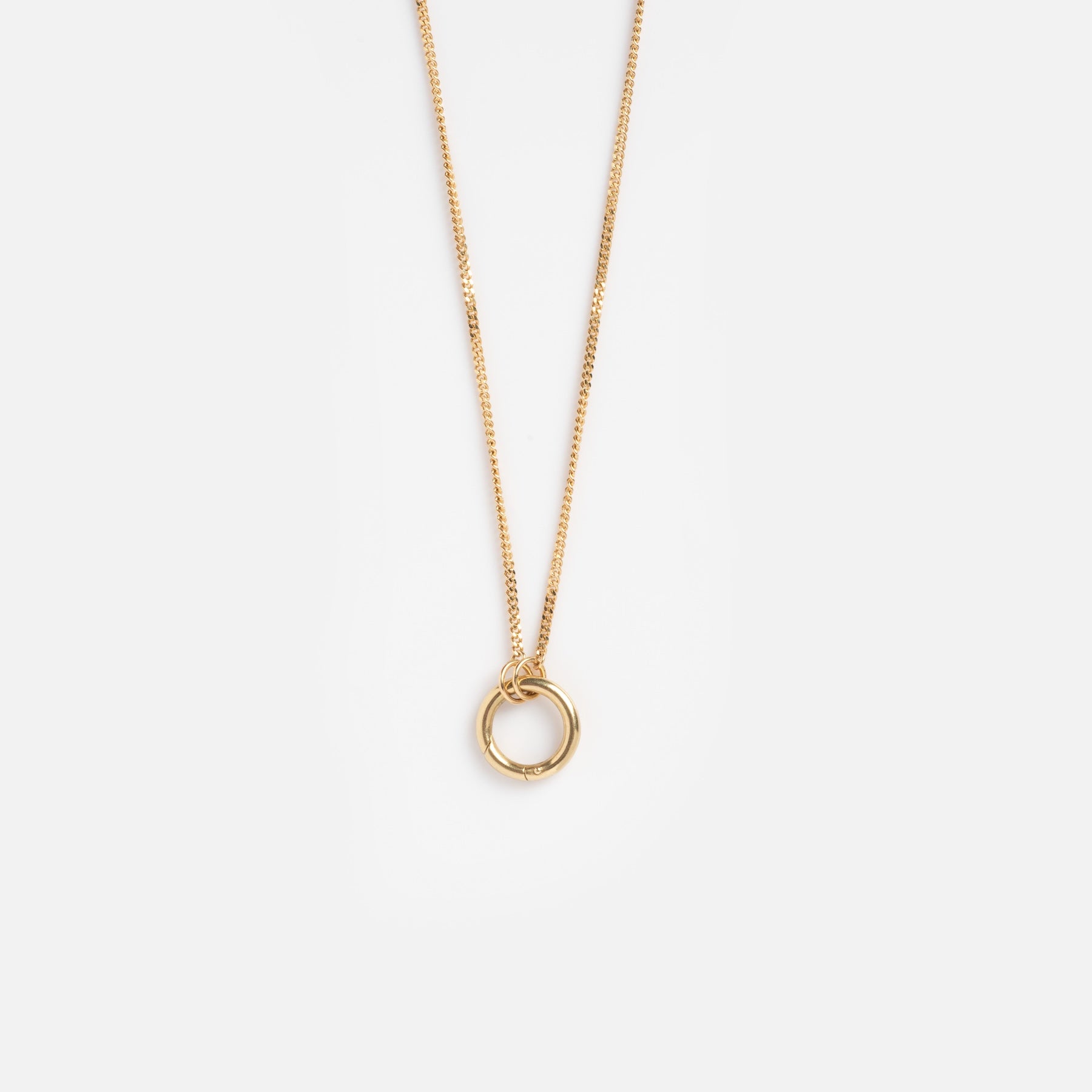 The Solid Gold Perfect Start Charm Holder Necklace features a simple 9k gold circular pendant, ideal for charm stacking, and is displayed against a plain white background.
