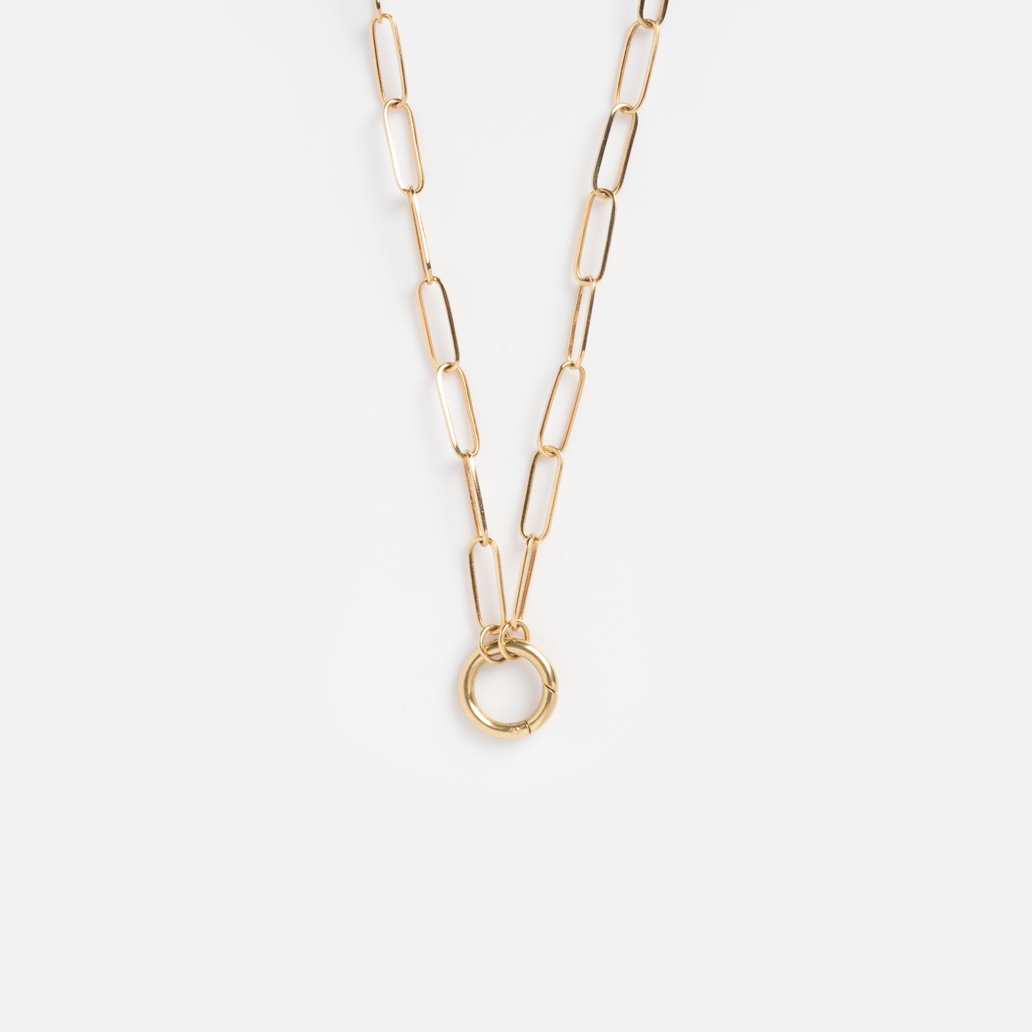 The Solid Gold Perfect Start Charm Holder Necklace, crafted in 9k gold with elongated oval links and a circular pendant, is shown on a plain white background—ideal for stacking your favorite charms.