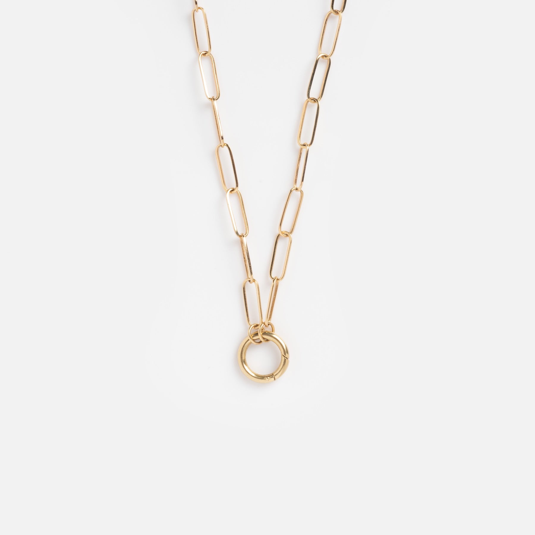 The Solid Gold Perfect Start Charm Holder Necklace, crafted in 9k gold with elongated oval links and a circular pendant, is shown on a plain white background—ideal for stacking your favorite charms.