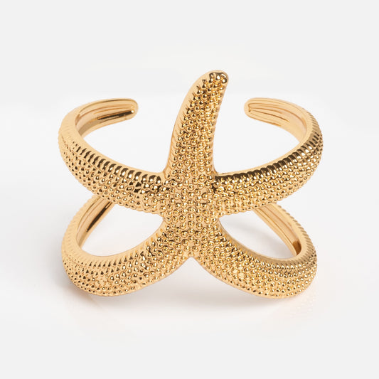 The Golden Nautilus Shell Cuff is a gold cuff bracelet with a nautilus shell design and an open adjustable band, shown on a white background.