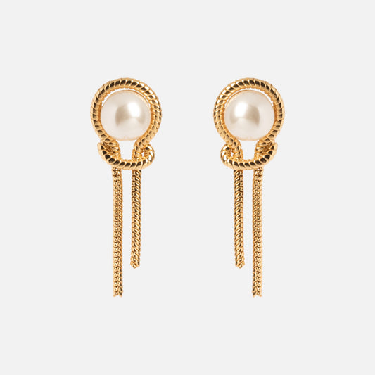 The Pearl Knot Earrings feature a twisted rope design in gold, a central pearl, and two dangling chains below each earring, shown on a plain white background.
