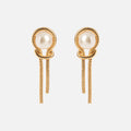 The Pearl Knot Earrings feature a twisted rope design in gold, a central pearl, and two dangling chains below each earring, shown on a plain white background.