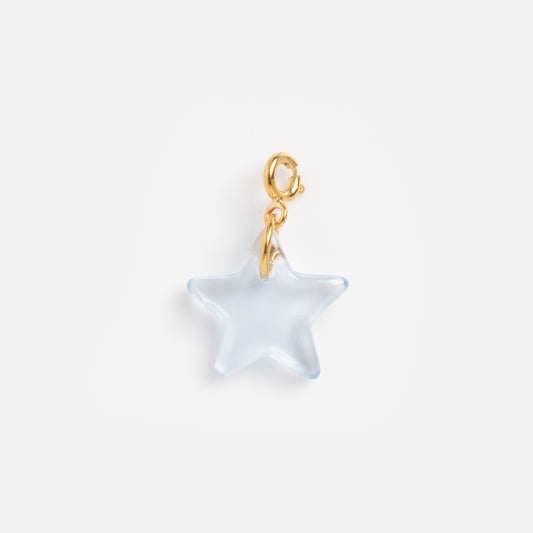 The Charms by CLED is a star-shaped, translucent light blue charm made from recycled glass, featuring a yellow gold vermeil jump ring and clasp, shown isolated on a white background.