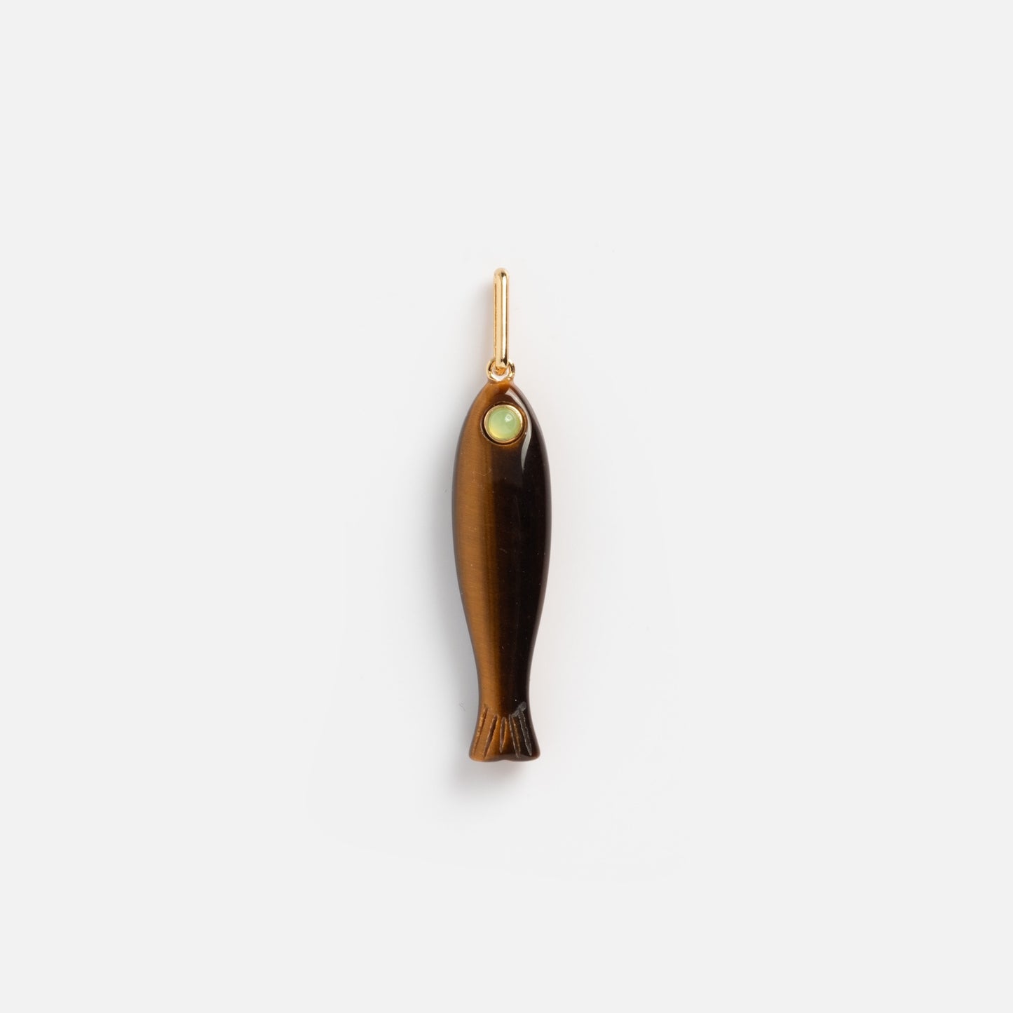 The Charms by Thatch pendant features a brown, polished fish shape with a small green eye detail, hanging from a simple gold loop. This bold necklace charm pops against its plain white background—ideal for statement jewelry lovers.