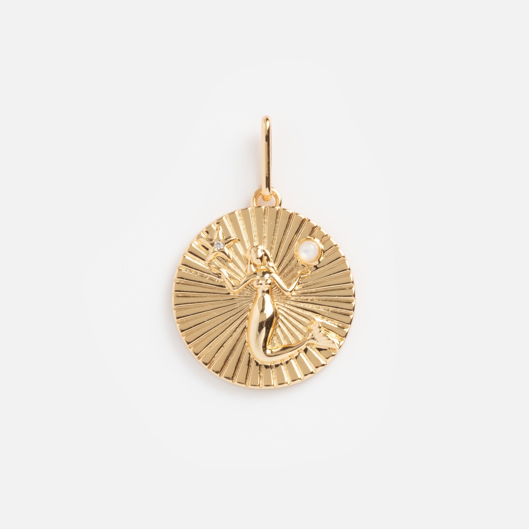 The Charms by Thatch 14k gold plated round pendant features an engraved mermaid holding a pearl on a textured, radiating background. It includes a small loop for easy attachment to chains or custom jewelry creations.