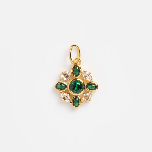 The 2026 May Capsule Vintage Inspired Emerald Charm features a yellow gold vermeil pendant with a round green gemstone, four oval gems, and clear stones in an ornate, symmetrical design—perfect as an elegant May birthstone charm.