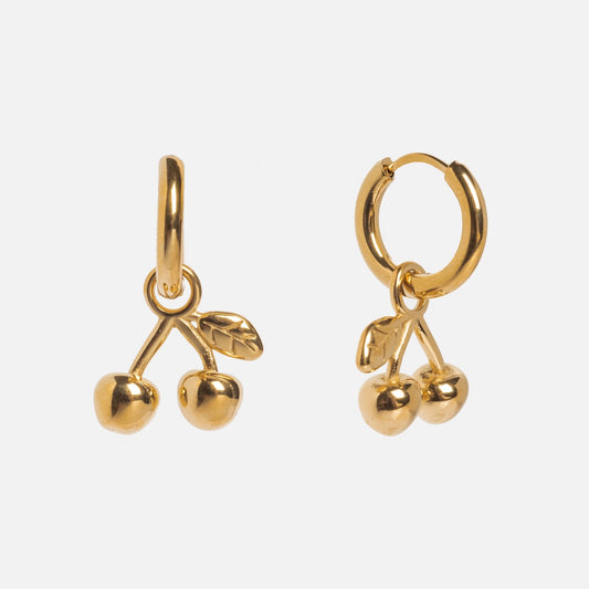 Cherry Charm Huggies by Petit Moments: gold huggie earrings each with a dangling charm featuring two cherries and a leaf, shown on a plain white background.