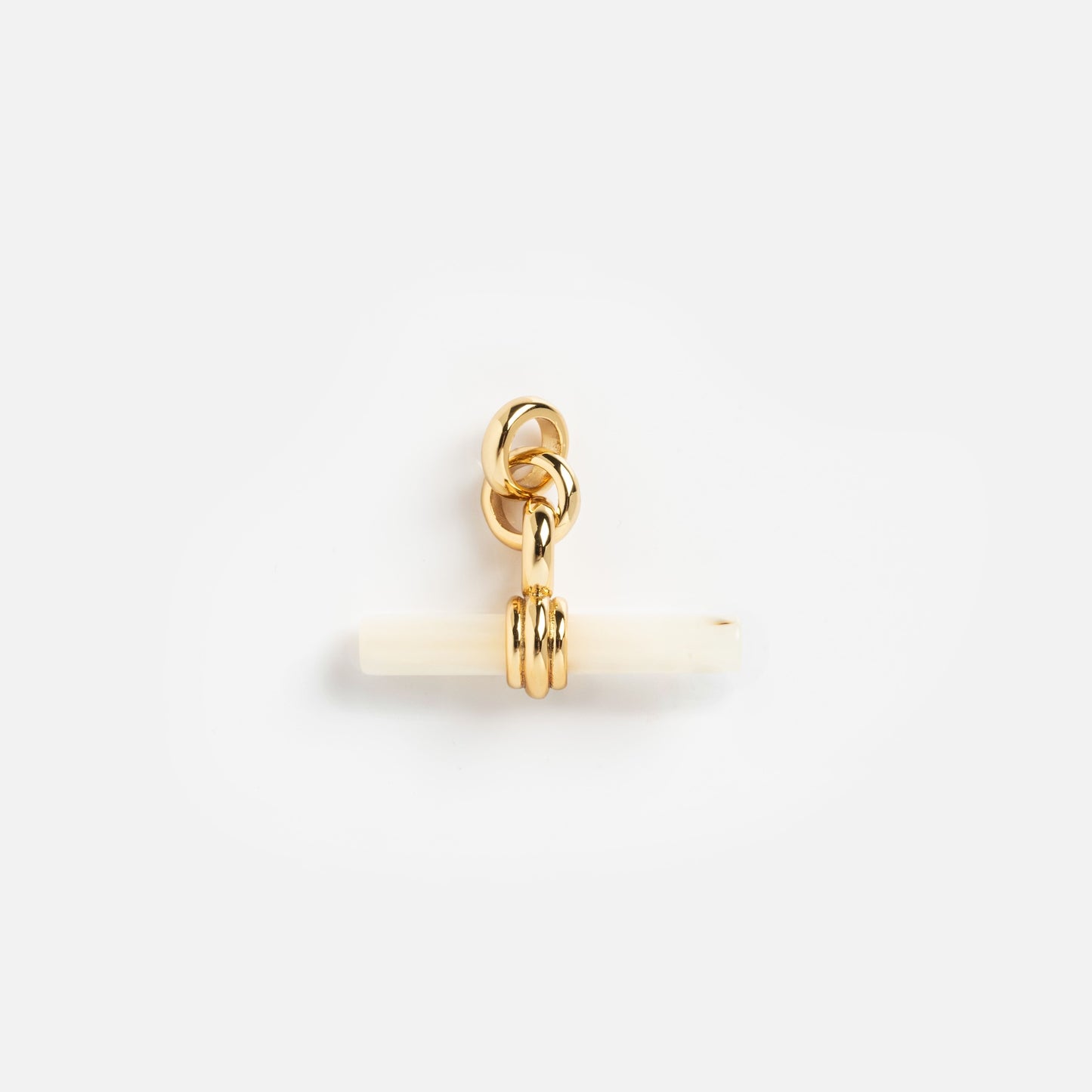 Charms by Mod + Jo: A petite gold-plated pendant with interlocking rings and a horizontal white bar, set against a simple background—an elegant piece perfect as a good luck charm.