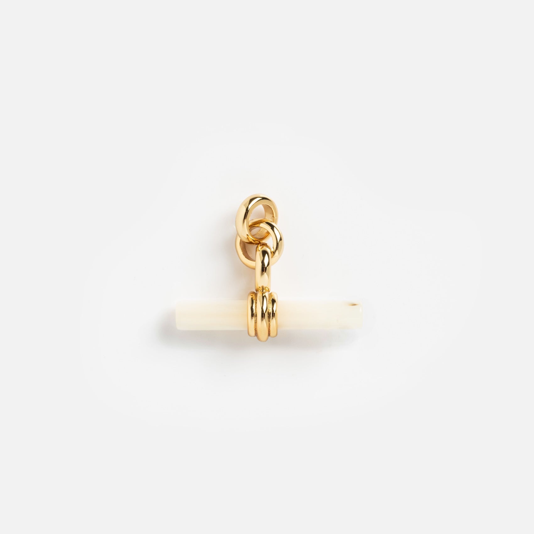 Charms by Mod + Jo: A petite gold-plated pendant with interlocking rings and a horizontal white bar, set against a simple background—an elegant piece perfect as a good luck charm.