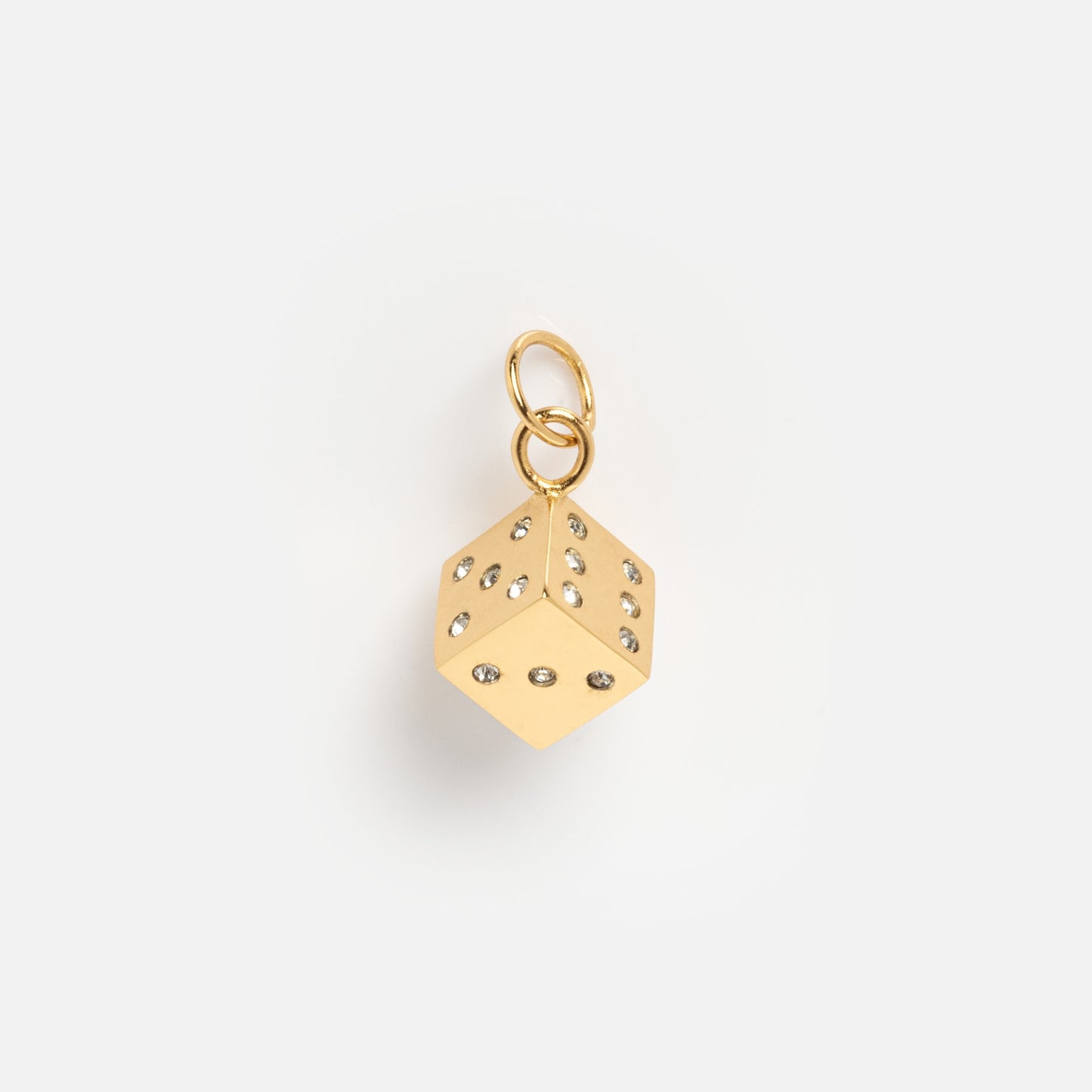 Charms by Mod + Jo: A gold-plated dice-shaped good luck charm featuring diamond-like stones on each face and a gold loop, presented on a plain white background.