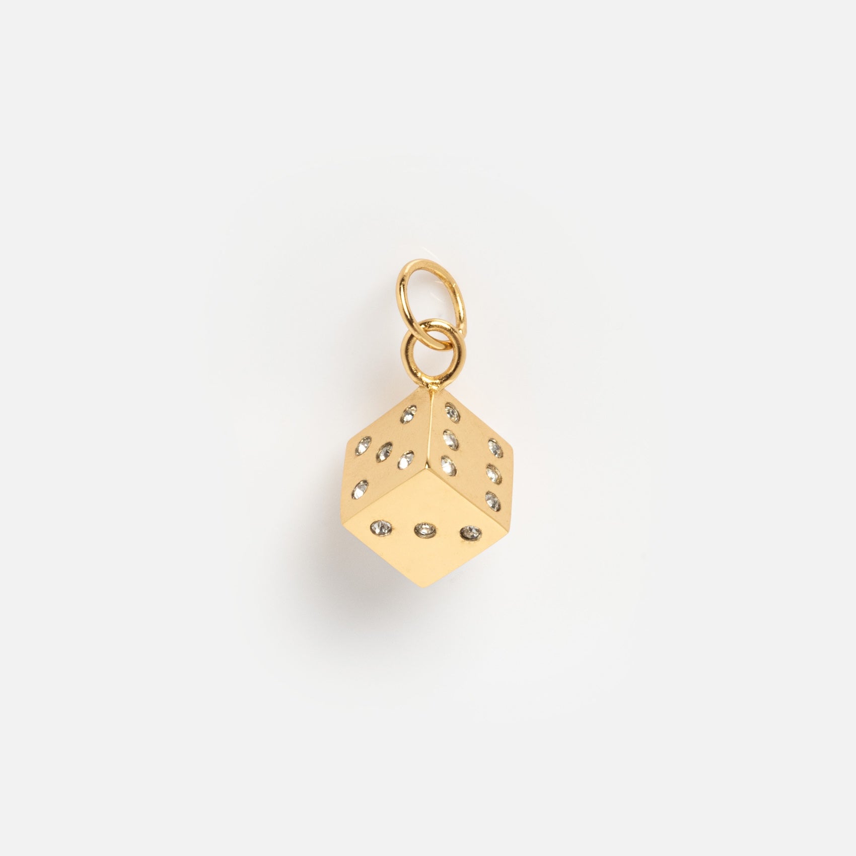 Charms by Mod + Jo: A gold-plated dice-shaped good luck charm featuring diamond-like stones on each face and a gold loop, presented on a plain white background.