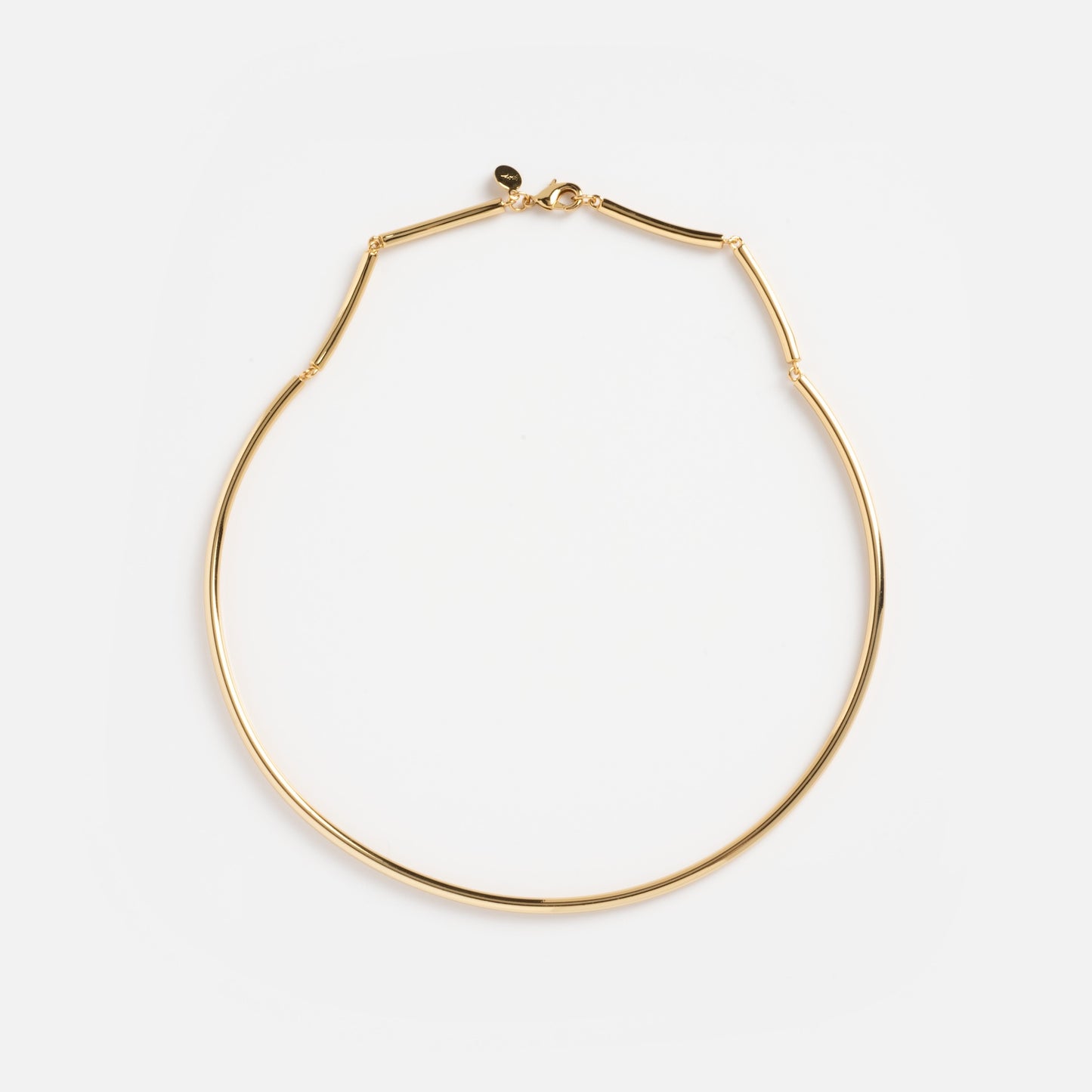 The Hayes Collar Necklace is a thin gold choker featuring a minimalist design and small clasp, displayed flat on a white background.
