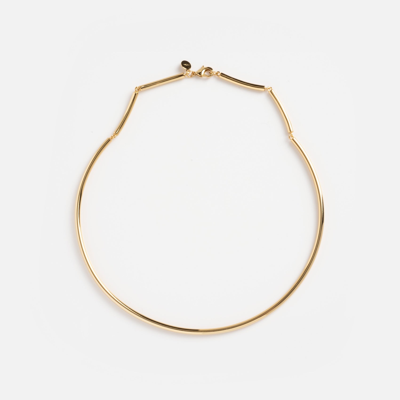 The Hayes Collar Necklace is a thin gold choker featuring a minimalist design and small clasp, displayed flat on a white background.