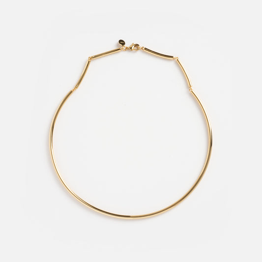The Hayes Collar Necklace is a thin gold choker featuring a minimalist design and small clasp, displayed flat on a white background.