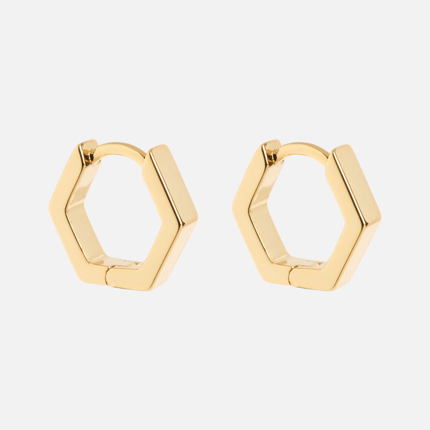 Ari Hoops: gold hexagonal hoop earrings showcased on a plain white background.