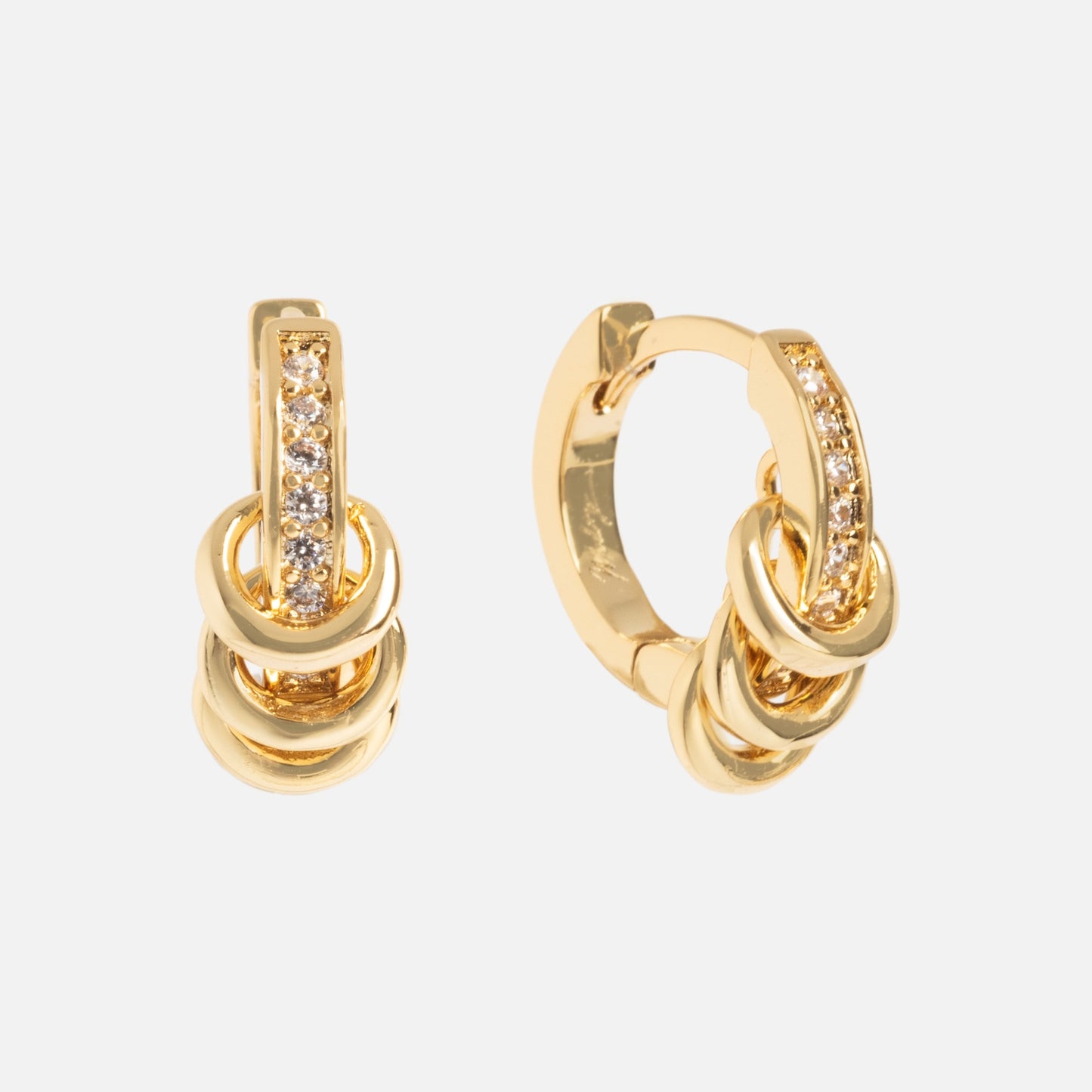 The Levi Huggies are gold hoop earrings with three interlocking loops and vertical rows of sparkling white stones set along the front, shown against a plain white background.