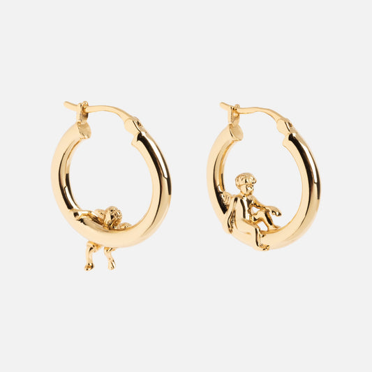 Cherub Hoops: gold earrings with small cherub figures—one lying on the hoop, the other sitting—displayed against a plain white background.