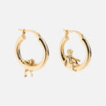 Cherub Hoops: gold earrings with small cherub figures—one lying on the hoop, the other sitting—displayed against a plain white background.