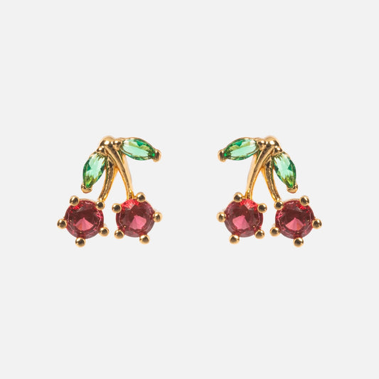 Juicy Cherry Studs: Gold plated, 90s-inspired earrings with two red gemstones as cherries and green gems as leaves, adding a playful pop of color. Displayed on a plain white background.
