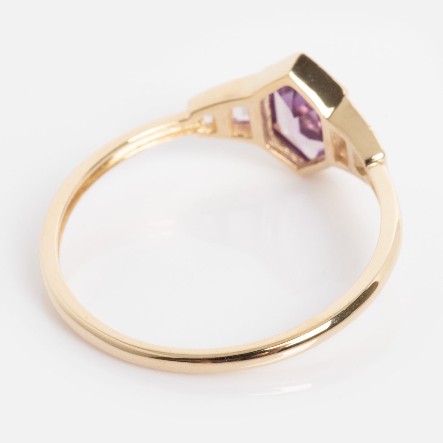 The Solid Gold 2026 June Capsule Art Deco Alexandrite Ring features a faceted purple gemstone in a geometric bezel, shown on a white background.