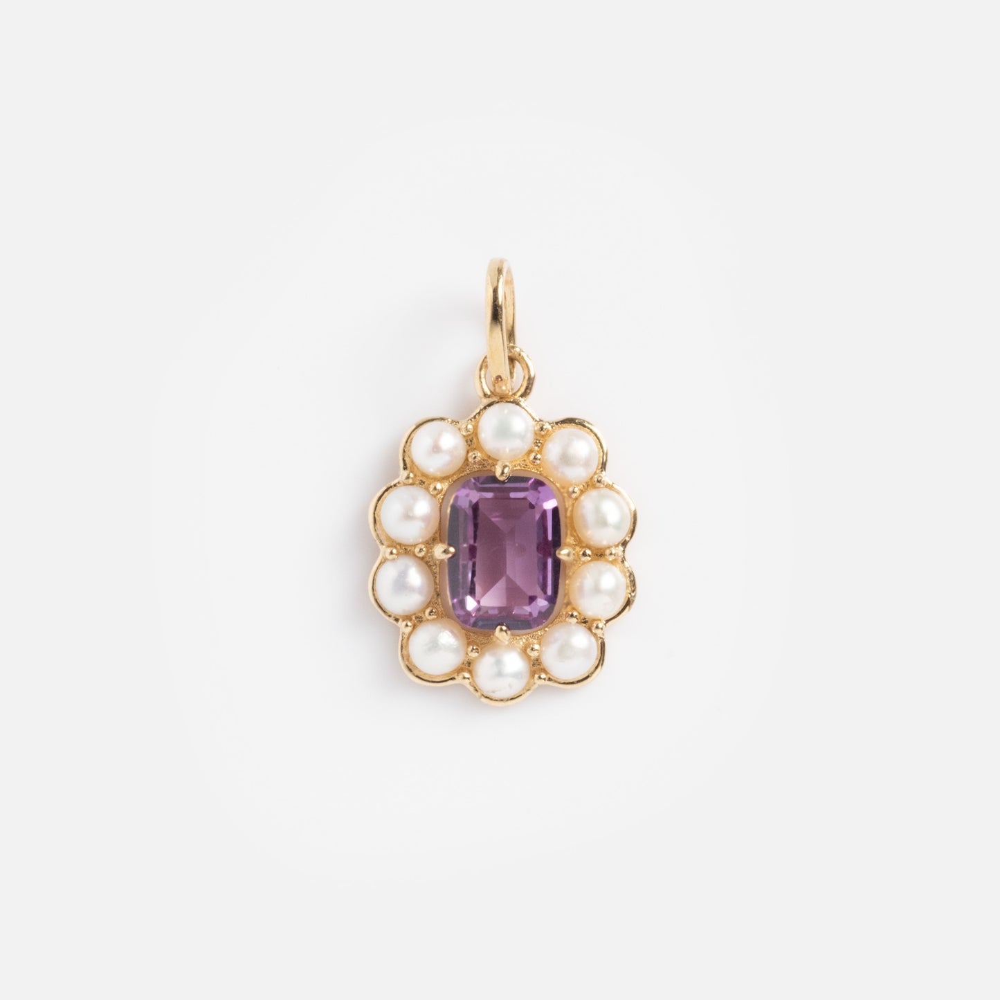 The Solid Gold 2026 June Capsule Vintage Inspired Alexandrite and Pearl Charm features an oval halo of white pearls around a central rectangular alexandrite, completed with a top loop for easy attachment to your favorite chain.