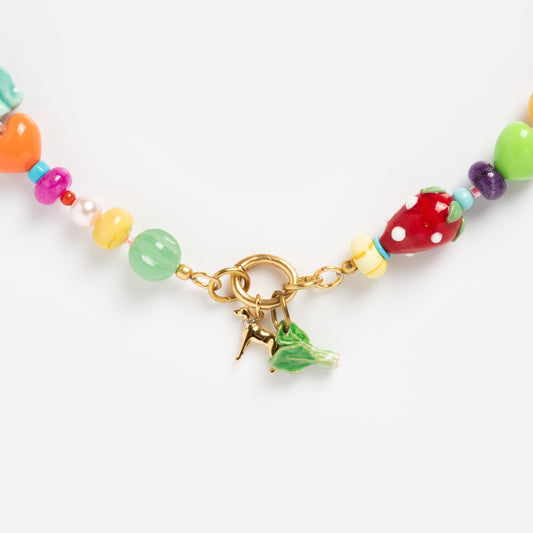 The Beaded Gemstone Charm Holder Necklace features vibrant multicolored beads and two gold charms—a green leaf and an Eiffel Tower charm holder—displayed on a white background, perfect for lovers of gemstone statement necklaces.