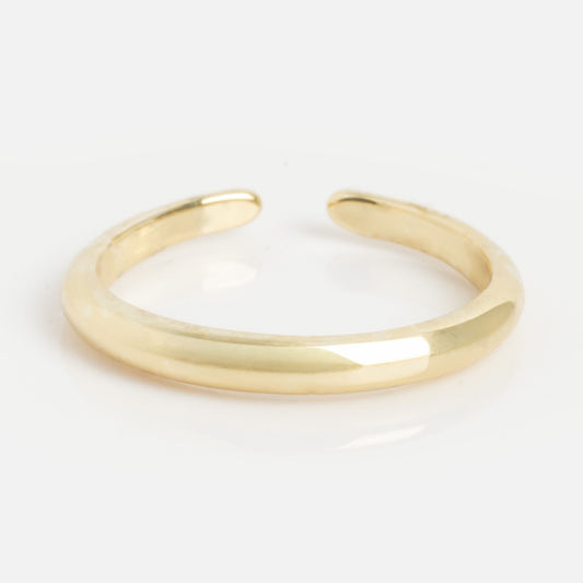 The Base Toe Ring is a simple, polished gold band with a smooth, rounded finish—ideal minimalist toe ring beach jewelry—shown on a white background.