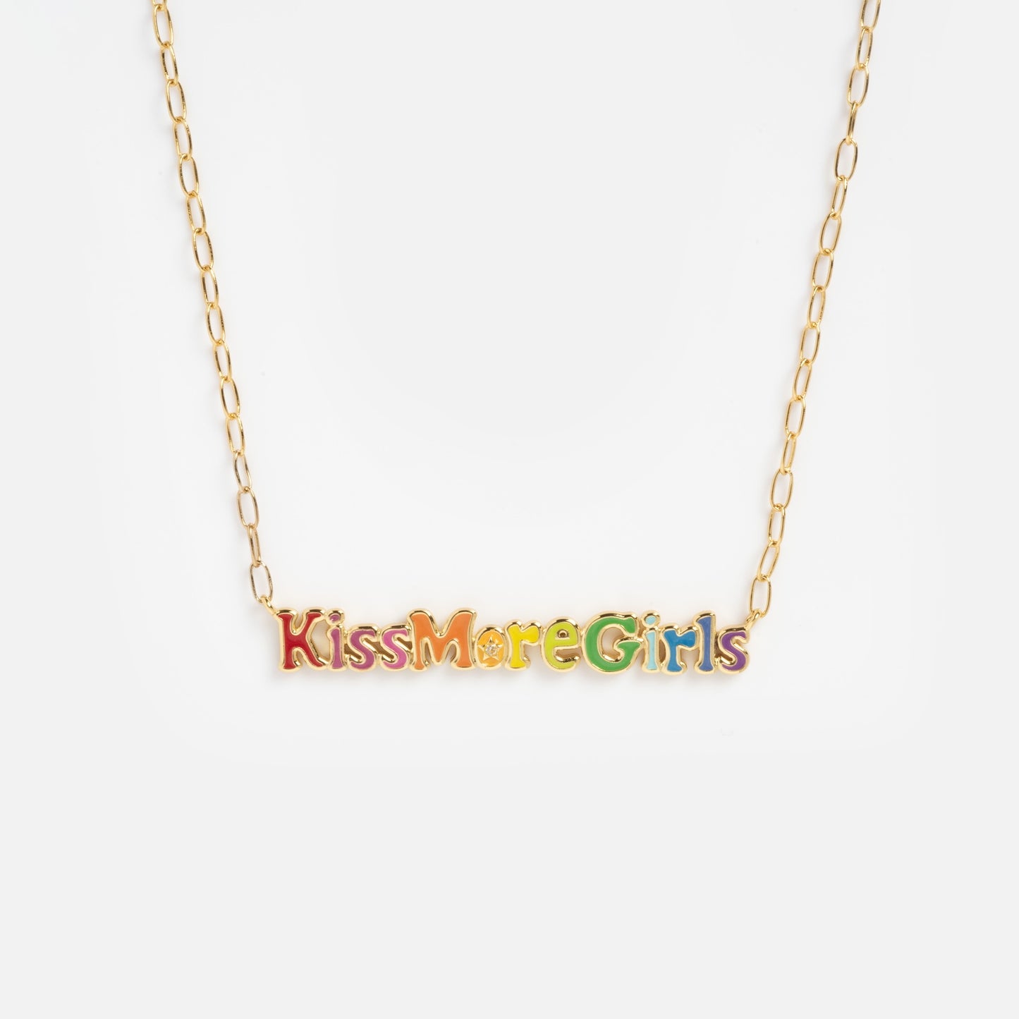 The Kiss More Girls Necklace features a gold chain with colorful letters spelling "Kiss More Girls" in a playful font, displayed on a plain white background.