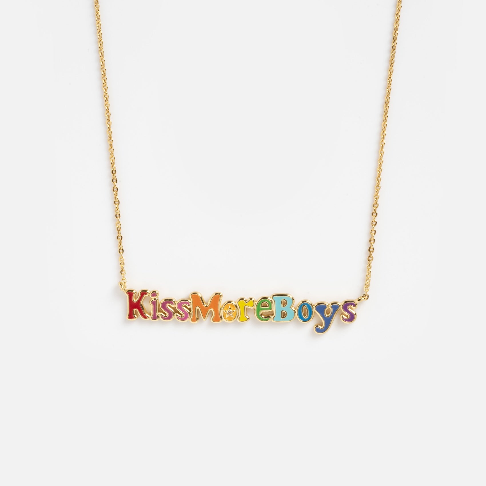 The Kiss More Boys Necklace features a gold chain with a rainbow-colored pendant spelling out "Kiss More Boys," shown on a plain white background.