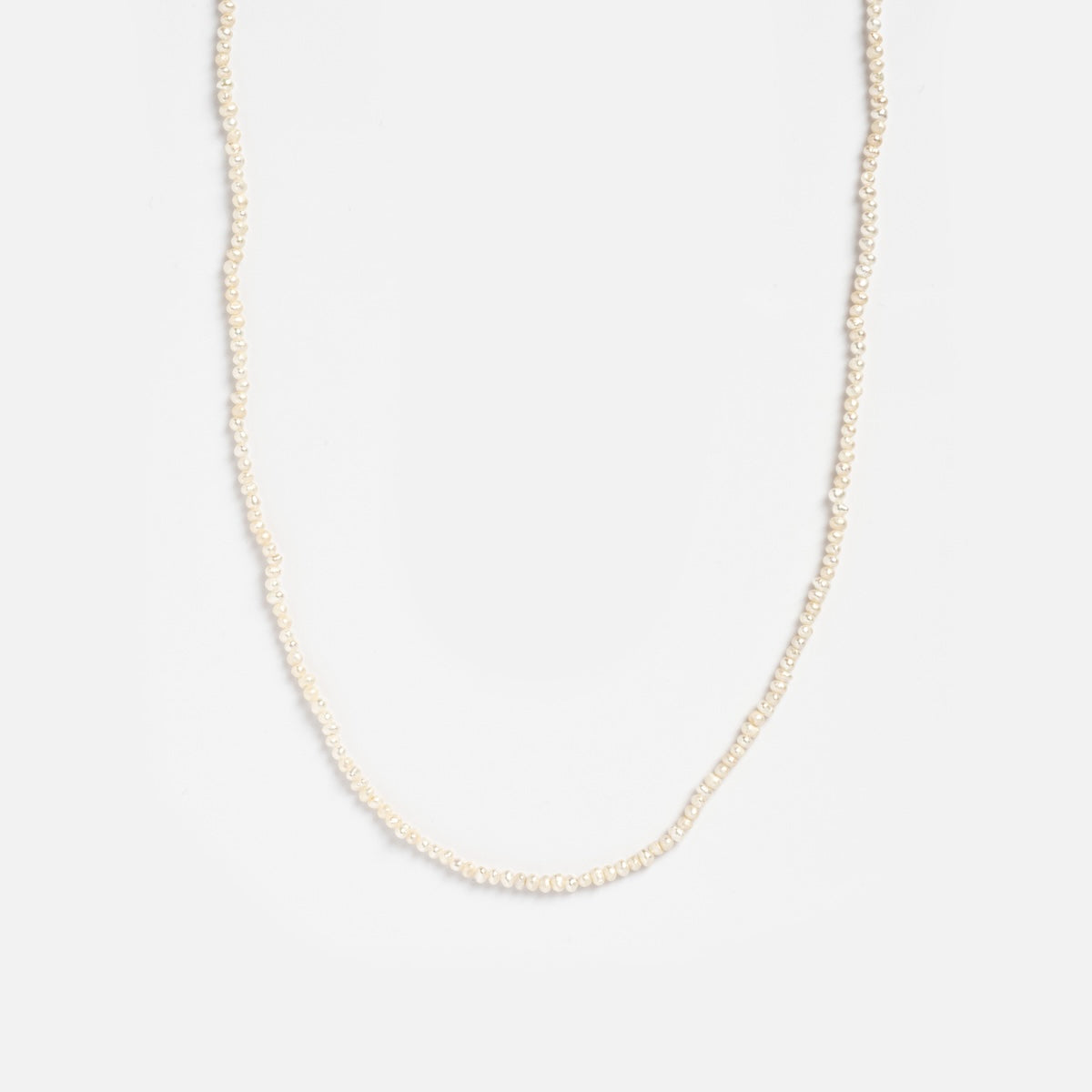 The Vermeil Delicate Pearl Chain features small, evenly spaced white pearls in a single strand, showcased against a plain white background.