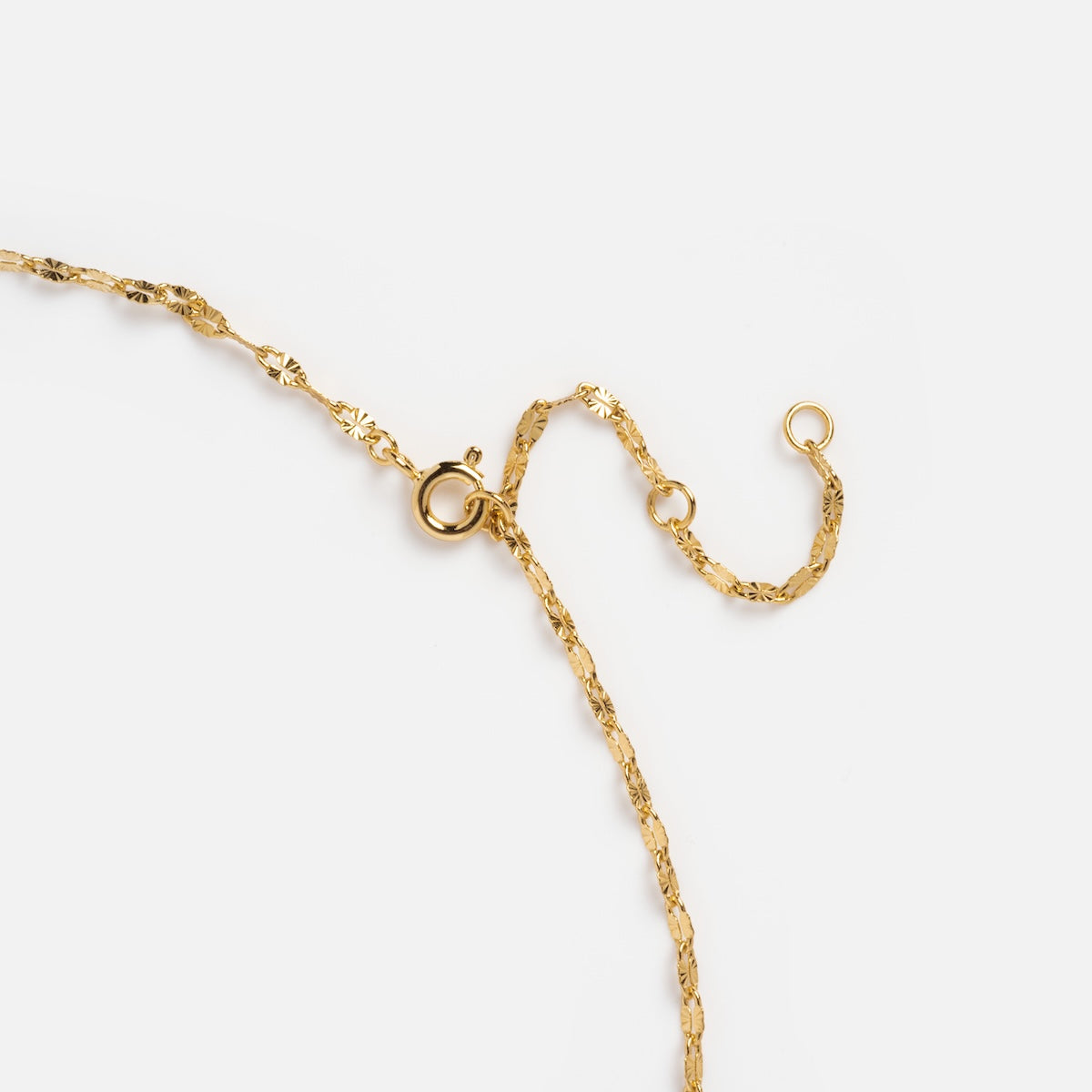 The Sparkle Link Chain, a delicate textured gold plated necklace with a spring ring clasp, is displayed on a plain white background.