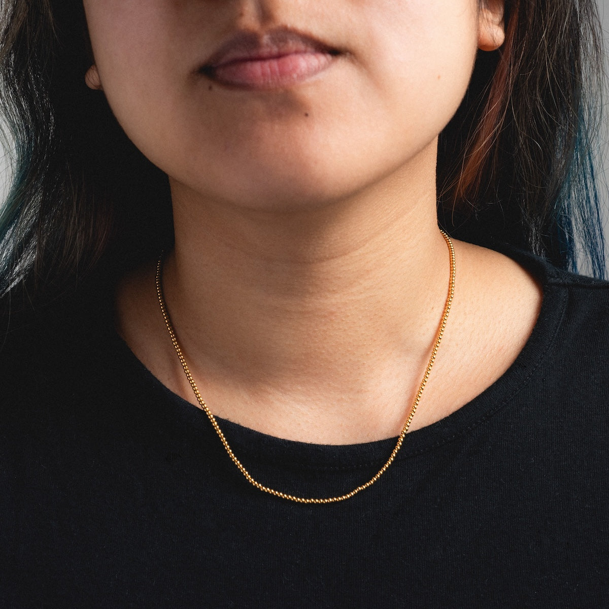 Woman wearing beaded vermeil necklace