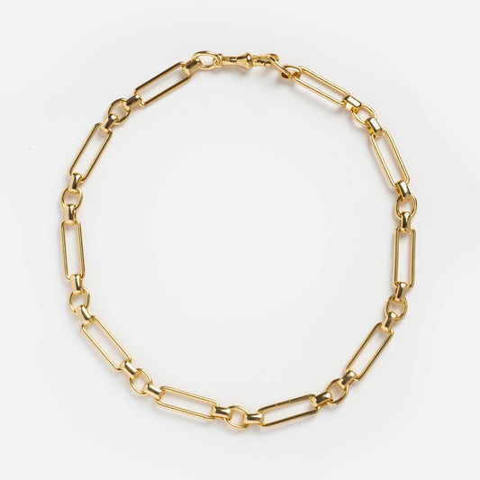 The Constance Necklace is a bold, modern piece featuring large, elongated rectangular links in a circular design, plated in 18k gold and displayed on a plain white background.