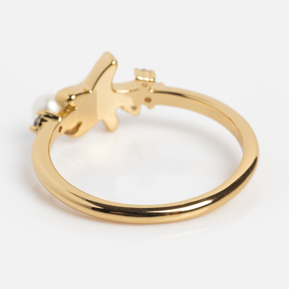 Gold ring with a star design on a white background
