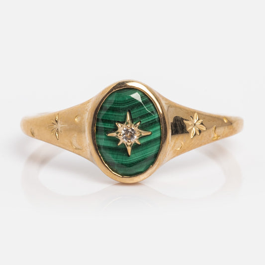 The Solid Gold Crystal Signet Ring for Manifestation features a green Malachite stone, a star design, and is crafted in 9k yellow gold. Available in sample size 7.