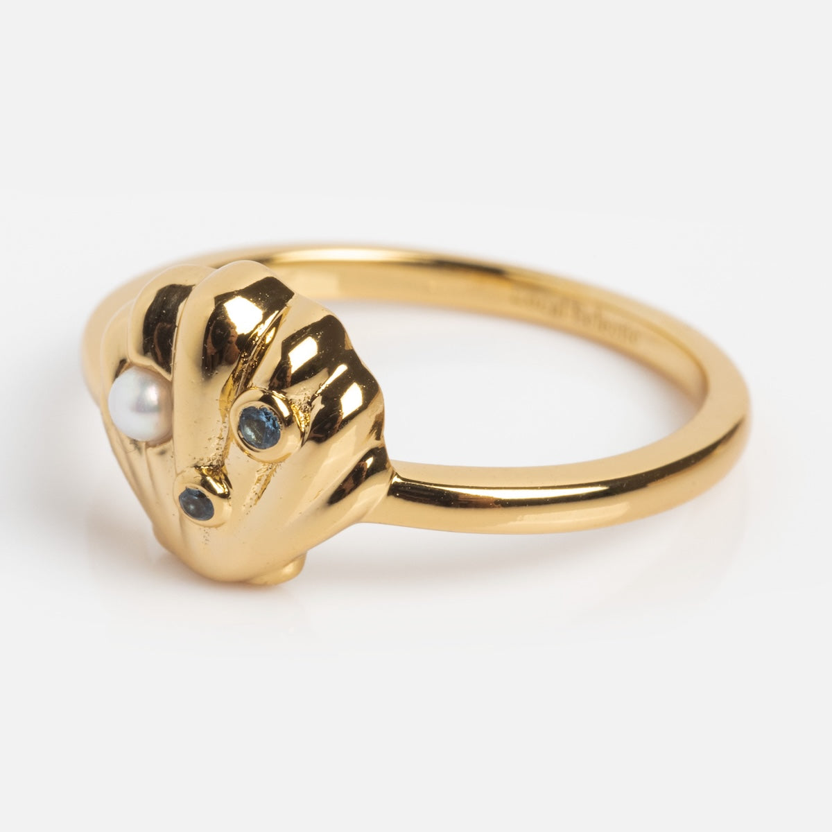Gold ring with a unique design on a white background