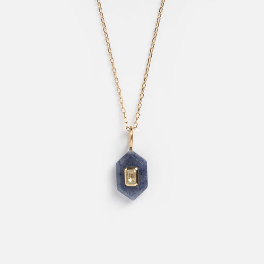 The Solid Gold Aura Necklace Blue Sample features a gold chain and a hexagonal Blue Aventurine pendant with a rectangular 9k solid yellow gold accent at its center, shown on a white background.