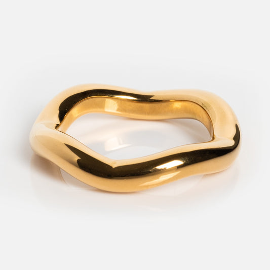 The Poppy Ring features a wavy, irregular design and a smooth, polished surface. This stunning piece is 18k gold plated for a luxurious finish and shines against a plain white background.