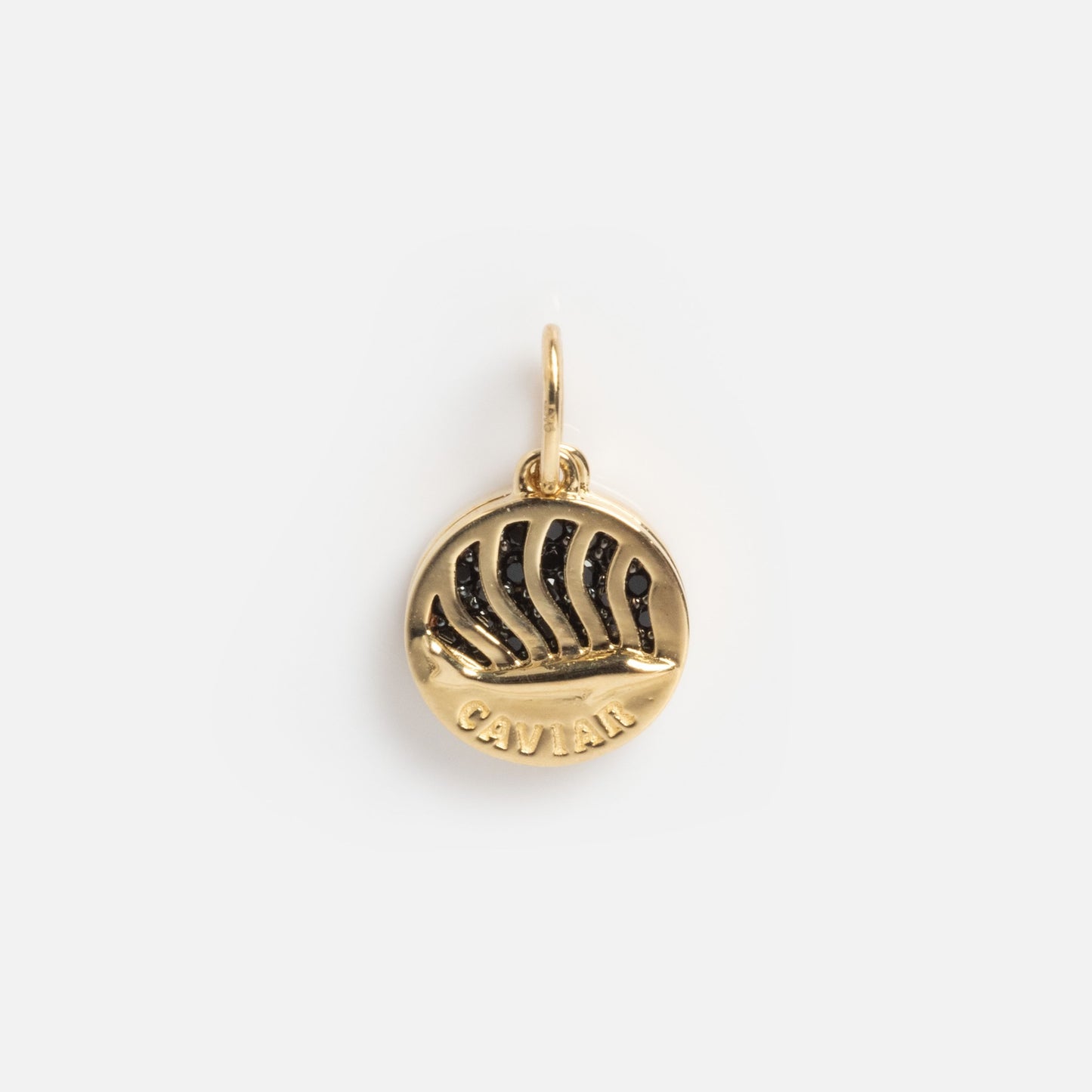 The Solid Gold Caviar Charm Sample is a round gold piece with a sailing ship relief, “CAVIAR” engraved beneath, and a top loop for attaching to a chain.