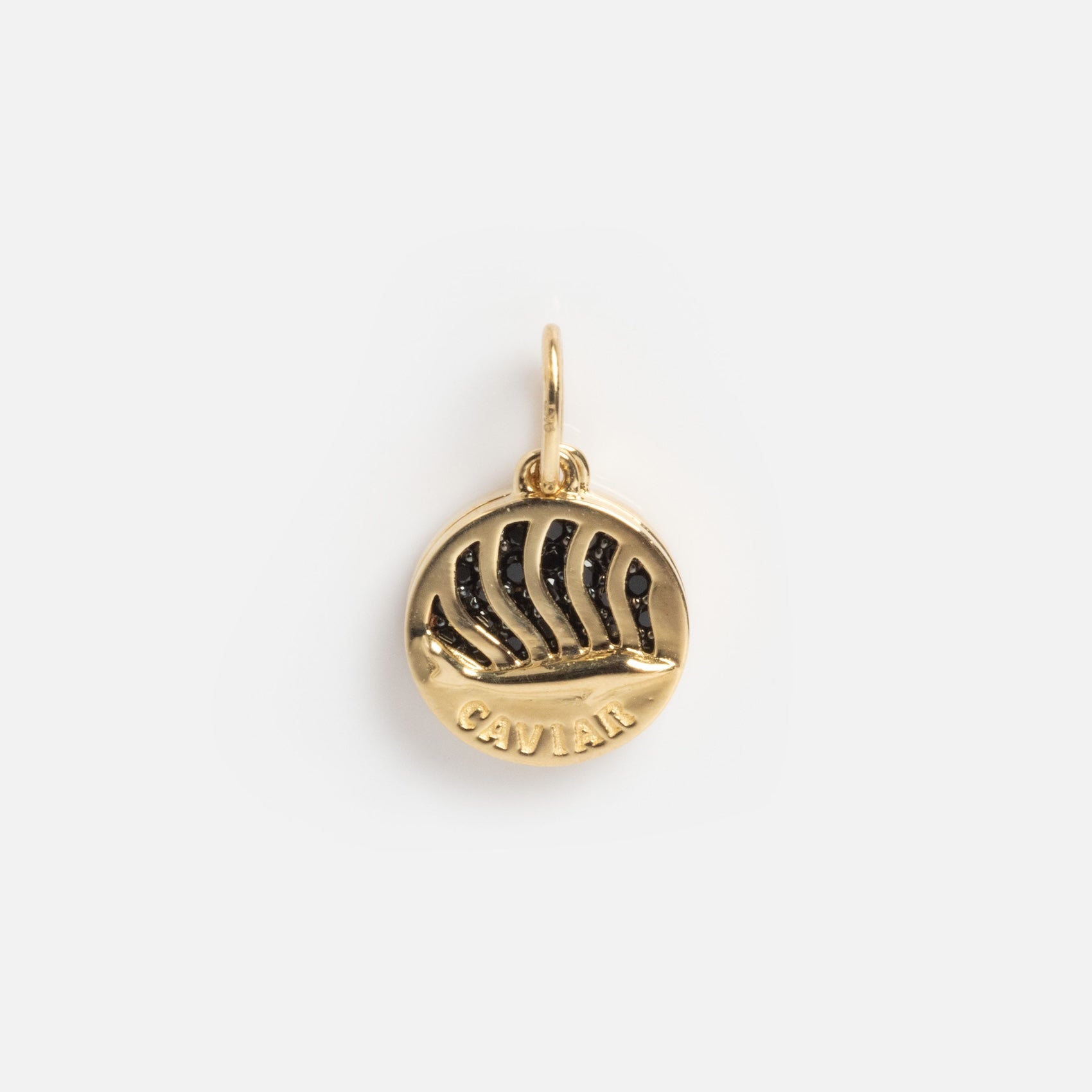 The Solid Gold Caviar Charm Sample is a round gold piece with a sailing ship relief, “CAVIAR” engraved beneath, and a top loop for attaching to a chain.