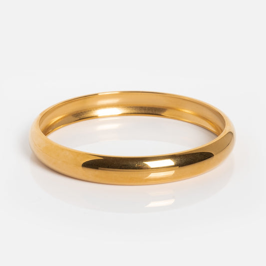 The Enza Small Bangle is a shiny 14k gold bracelet with a smooth, rounded surface, shown on a white background.