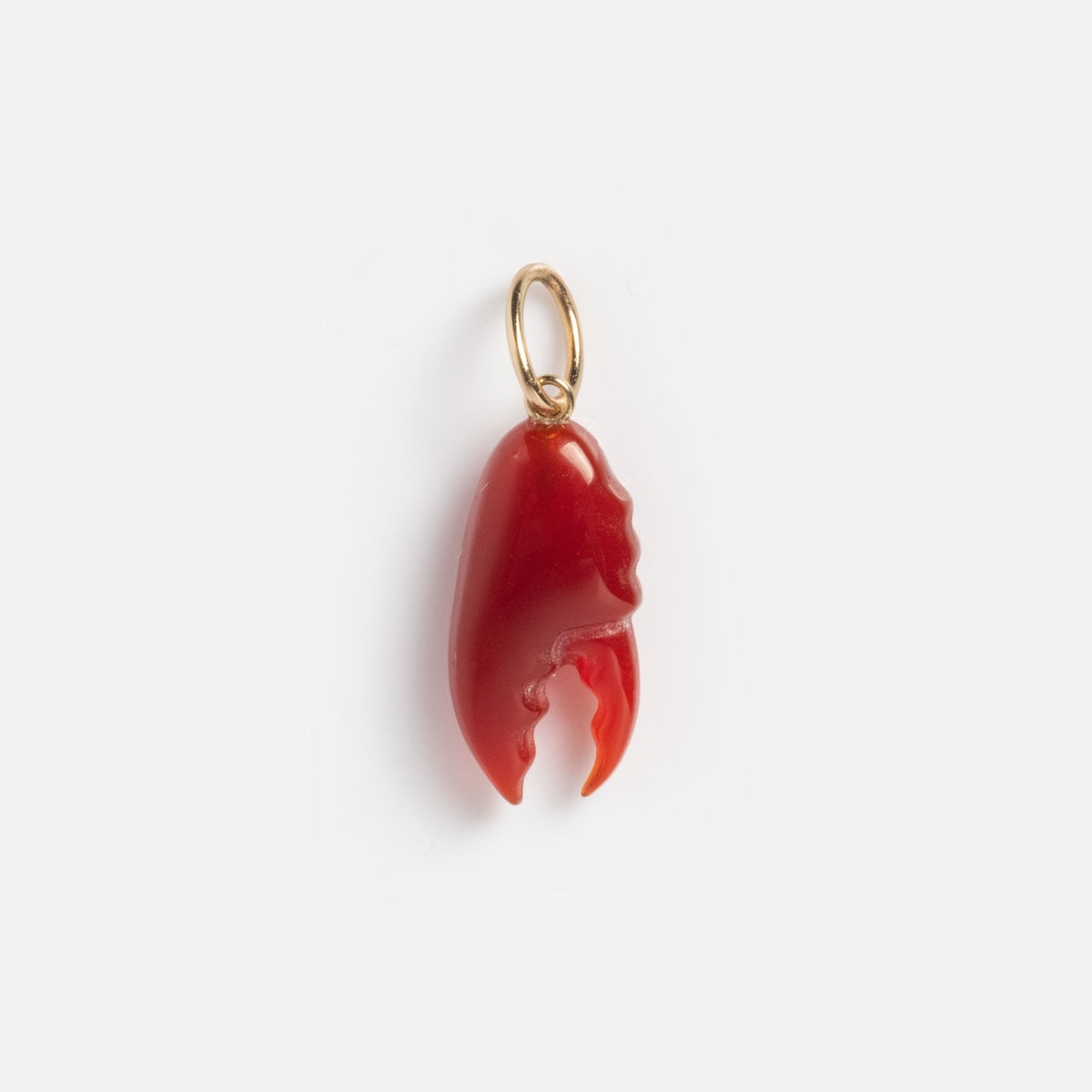 The Solid Gold Under The Sea Charm is a small red lobster claw charm with a gold loop for attaching to jewelry, capturing ocean beauty and shown elegantly on a plain white background.