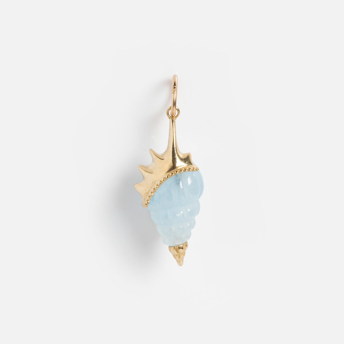 The Solid Gold Under The Sea Charm features a seashell design with light blue translucent material and gold accents, capturing a siren glow as it hangs from a gold loop.