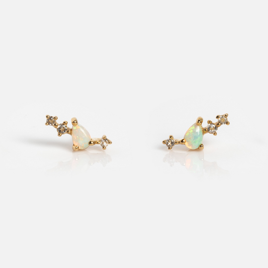 The Solid Gold Opal Constellation Flat Back Studs feature teardrop-shaped opals and star-like clusters of clear gemstones, all set against a white background.