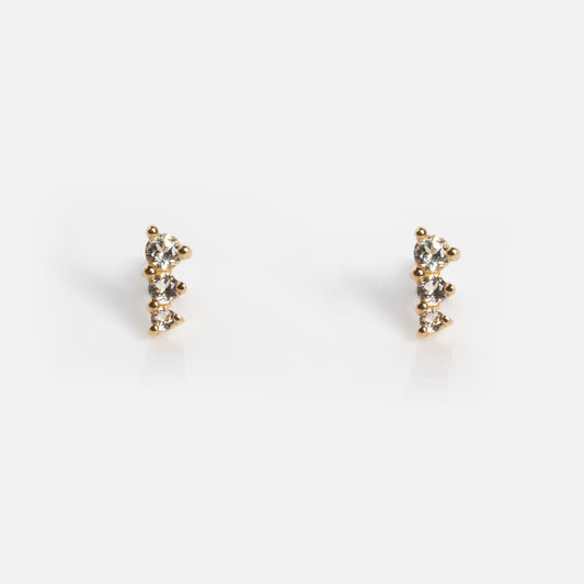A pair of Solid Gold Tapered Shimmer Flat Back Studs, each with three small round clear gemstones in a vertical line, displayed against a plain white background.