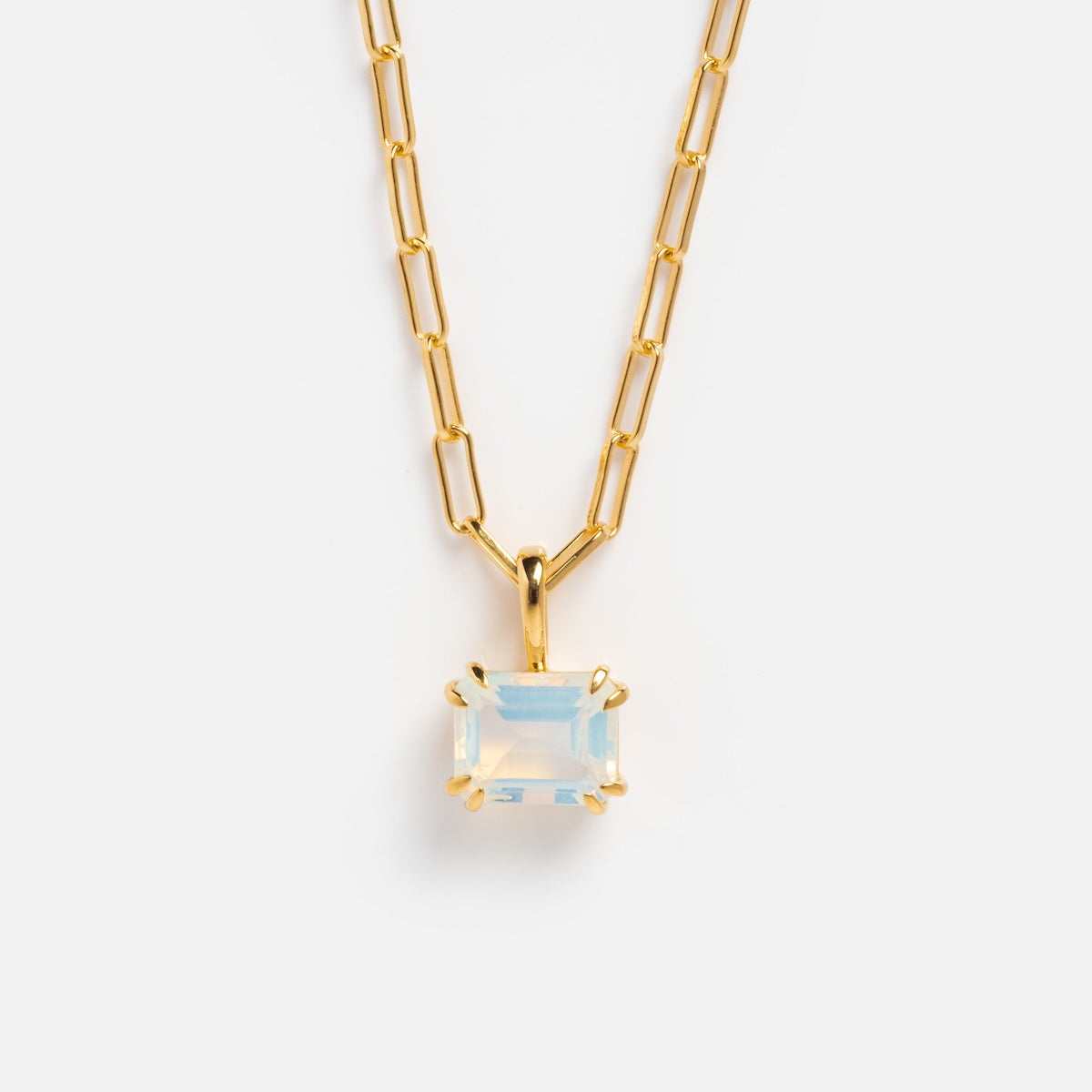 The Born to Shine Birthstone Necklace features a gold paperclip chain and a rectangular iridescent gemstone pendant in a gold prong setting, shown against a plain white background.