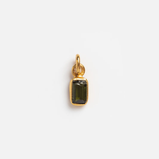 The Gemstone Charms by Anokhi Green features a small rectangular 18k gold vermeil pendant with a dark green gemstone in a gold frame and a top loop—an elegant upgrade to any gemstone charms collection.