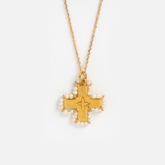 Close up of cross pendant with pearls