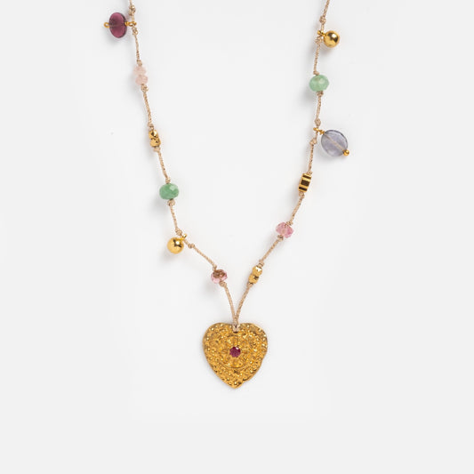 Close up of Neha necklace's beaded thread and heart pendant