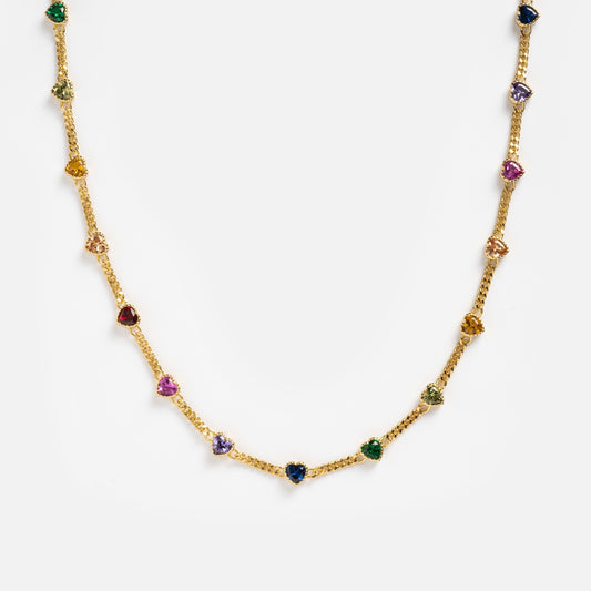 The Love Prism Rainbow Heart Necklace is a 14k gold plated chain with evenly spaced, multicolor heart gems in assorted shapes, shown on a white background.